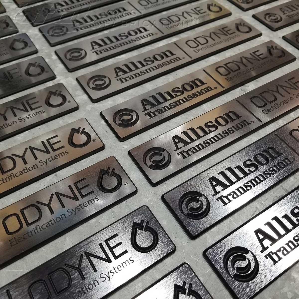 Pre-made stock of custom automotive emblems ready for shipping from Yofab.