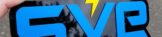 SVE Sunset Vans layered emblem in satin blue and satin yellow on gloss black with lightning bolt design.