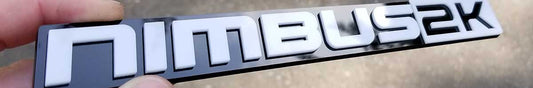 Nimbus 2K gloss white Slant font emblem on gloss black backing made from UV rated acrylic held outdoors.